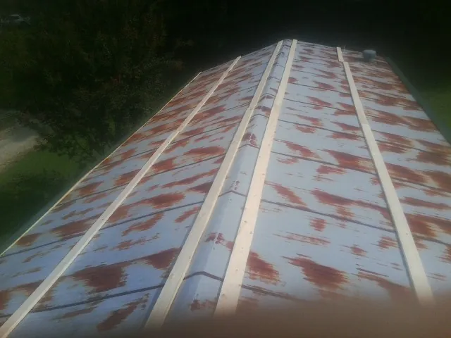 Rusted metal roof panels with new wood purlins before replacement — Storm Damage Roof Repair in Temecula by Roofing Brothers
